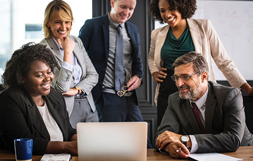 business people gathering around a computer