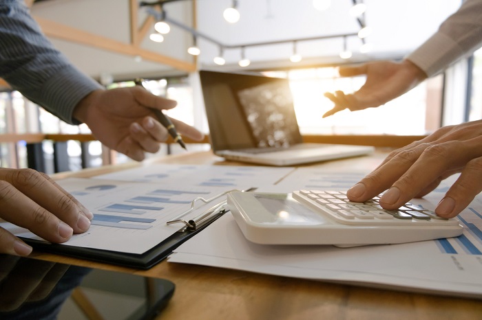 business discussion in office with computers and calculators